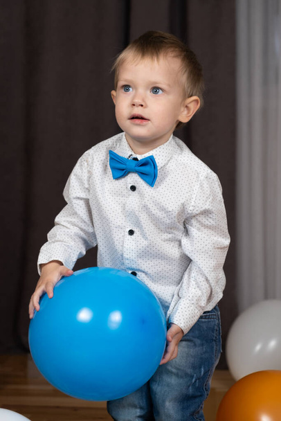 Δύο-year-old παιδί παίζει με ένα μπλε μπαλόνι - Φωτογραφία, εικόνα