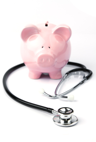 Piggy bank and stethoscope on white - Photo, Image