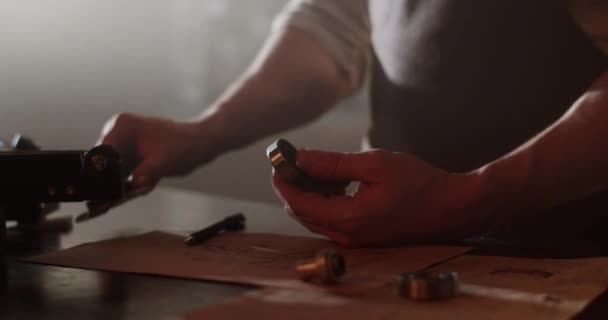Captura de mano en tiempo real del maestro masculino anónimo de la cosecha usando la pinza mientras mide la parte y luego toma notas en el taller creando el modelo 3D - Metraje, vídeo