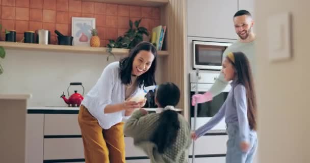Fun, family and kitchen dancing and chores in a home with kids, parents and cleaning with help. Love, work support and smile with broom and children in a house with happy mom and father together. - Footage, Video