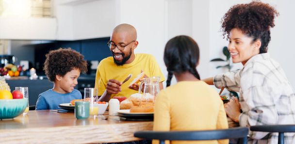 Black family, food and parents with kids for breakfast, lunch and eating together in home. Happy, serving and mom, dad and children for bonding with meal for health, nutrition and hunger in house. - Photo, Image