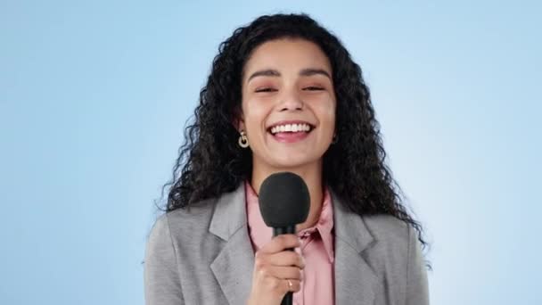 Stüdyoda röportaj için mavi arka planda bir kadın muhabirle yüz, mikrofon ve haberler. Portre, gülümseme ve gazetecilik ve mutlu genç bir sunucu sunum için televizyonda konuşuyor.. - Video, Çekim
