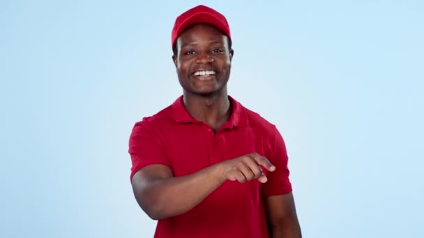 Delivery guy, space or pointing to offer, discount or distribution promotion on blue background. Face of happy black man, wrong choice or mockup for post service, sale or good review in studio. - Footage, Video