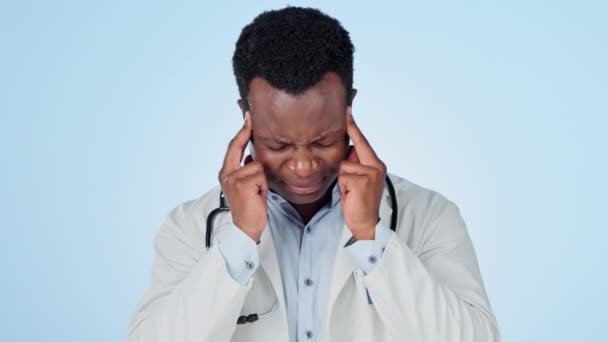 Black man, doctor and headache in stress, mistake or burnout against a studio background. Face of African male person, surgeon or medical employee with migraine, pain or mental health on mockup space. - Footage, Video