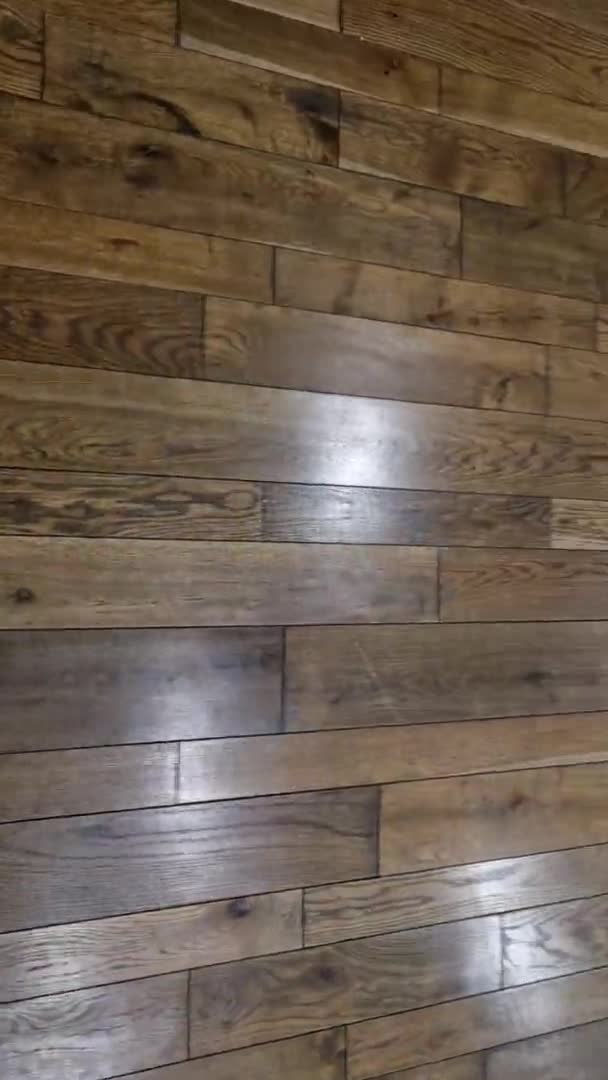  office or living room with a large glass window has a floor made of brown stained oak planks. warm air from the radiator register is unobtrusively vented out through the gap of the grid - Footage, Video