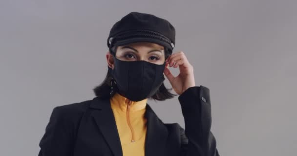 Cool, face mask and woman with fashion and style in studio, gray background and remove protection. Covid 19, aesthetic and portrait of person with confidence, pride and model with happiness and smile. - Footage, Video