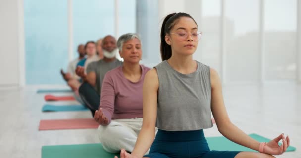 Woman, coach and zen meditation in yoga class for spiritual wellness, awareness or stress relief. Calm female person or yogi with group in mediating for healthy mind, body and health in fitness. - Footage, Video