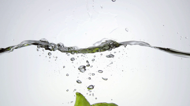 A carambola falling into water - Footage, Video