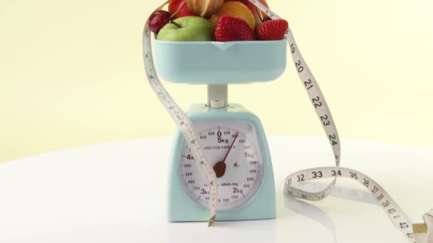 Fruits and tape measure on kitchen scales - Footage, Video