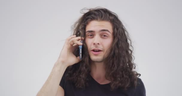 Face, phone call and man with communication, contact and connection on a white studio background. Portrait, person and model with a smartphone, network and discussion with internet and mobile user. - Footage, Video