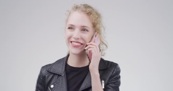 Phone call, contact and woman with conversation, communication and mobile user on a white studio background. Speaking, person and model with a smartphone, connection and chatting with network. - Footage, Video