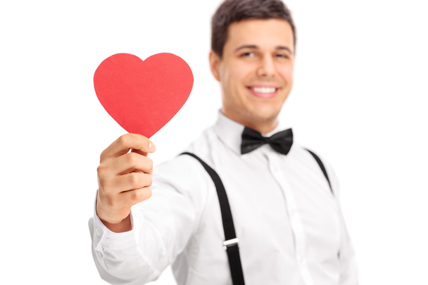 Guy holding heart shaped cardboard - Foto, Imagen