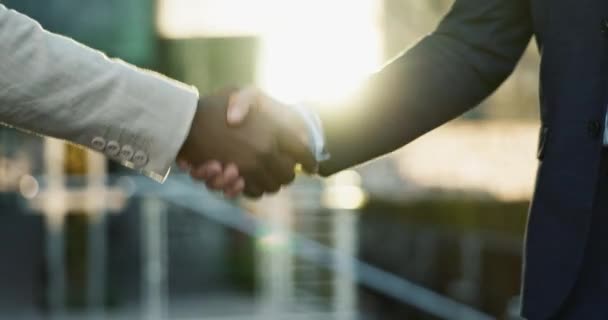 Business people, shaking hands and city meeting for b2b partnership, outdoor deal and travel success. Corporate or professional clients handshake for consulting, welcome or introduction in urban town. - Footage, Video