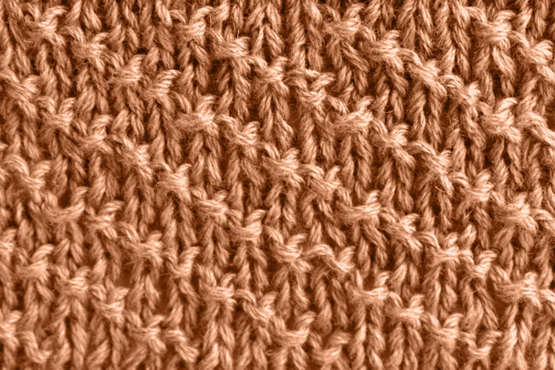 Персиковая шерсть вязана с диагональными полосками. Цвет года 2024. - Фото, изображение