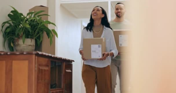 Moving, boxes and couple with package and new home investment excited from sale and mortgage. Dream house, smile and property with real estate and cardboard box with a happy woman and man together. - Footage, Video