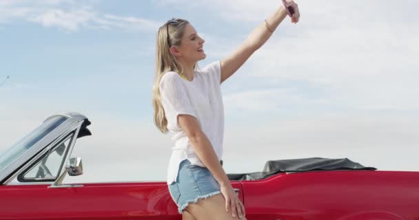 Adventure, selfie and woman by a car for road trip, vacation or weekend holiday in the coast. Transport, travel and young female person from Australia taking a picture with new luxury vehicle - Footage, Video