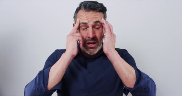 Stress, headache and mature business man in studio with pain, problem or mistake on grey background. Anxiety, migraine and male entrepreneur with temple massage for vertigo, brain fog or pressure. - Footage, Video
