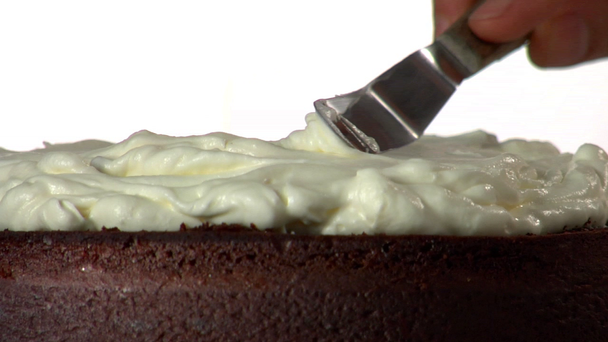 Chef spreading cream on cake - Footage, Video