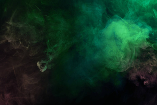 Green and pink steam on a black background. Copy space. - Photo, Image