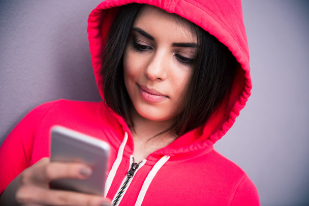 Portrait of a young beautiful woman with smartphone - Photo, Image