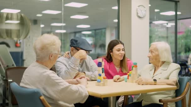 Video di un'infermiera tenera che si avvicina per parlare con persone anziane in geriatria - Filmati, video