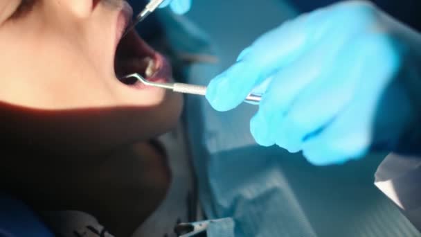 dentist examining boy's teeth with  dentistry tools  - Footage, Video