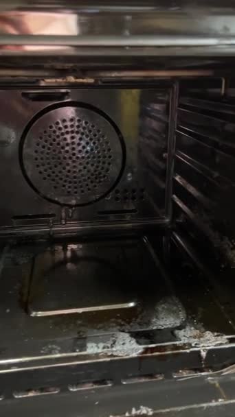 Woman wearing rubber gloves cleaning oven after cooking a fatty dish in the kitchen. Cleaning oven rack before and after. High quality  - Footage, Video