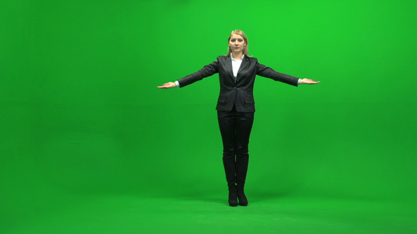 Businesswoman holding hands up on green screen - Footage, Video