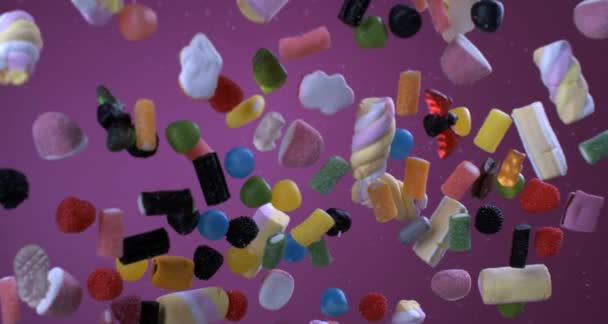 Vibrant colorful candies flying in the air in super slow motion. Assortment of sugary treats captured with a high speed camera - Materiał filmowy, wideo