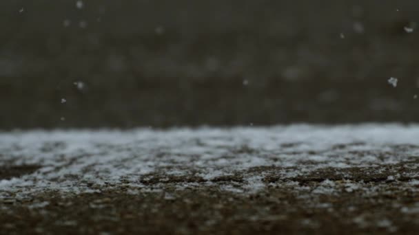 Snowflakes Descending onto Sidewalk Street in Super Slow Motion - Πλάνα, βίντεο