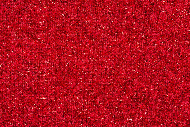 Piros pulóver szövet fényes részecskékkel. Karácsonyi háttér vagy borító - Fotó, kép