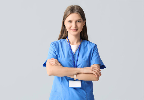 Beautiful young doctor on light background - Photo, Image