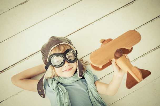 Happy child playing with toy airplane - Foto, Imagen