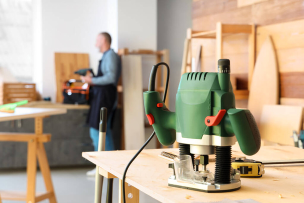 Modern milling machine on table in carpenter's workshop, closeup - Photo, Image