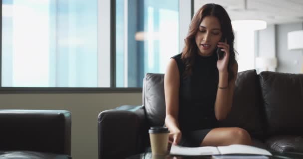 Business woman, phone call and thinking, planning or networking for recruitment and human resources in office. Professional worker with documents, reading resume or review CV with mobile chat on sofa. - Footage, Video