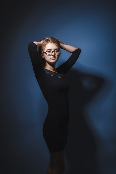 European appearance blonde girl with glasses in a black dress ho - Photo, Image
