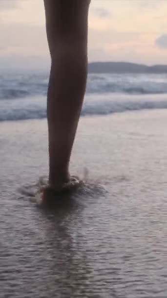  piernas de mujer en la arena caminando por el mar o el océano durante las vacaciones de verano o vacaciones. Playa, naturaleza y libertad con una hembra dando un paseo sola en la corriente, marea u olas - Imágenes, Vídeo