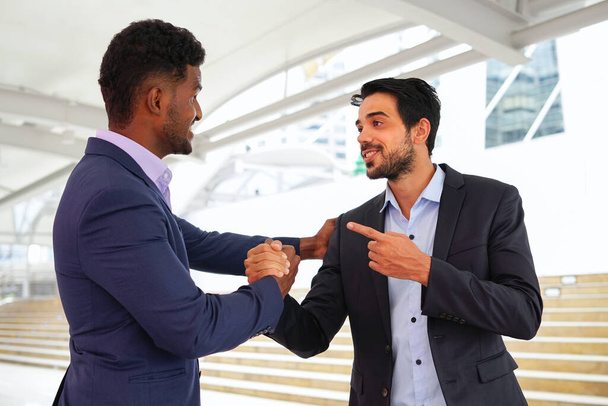 multiracial business colleague doing hands shake to greeting outside building,concept business people lifestyle,friendship,relationship                                 - Photo, Image