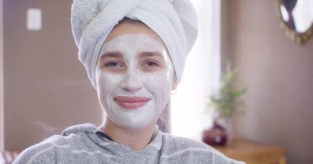 Woman, treatment and face mask for skincare at home, wellness and luxury product for selfcare. Female person, beauty and relax in portrait for cosmetics and smile in apartment, dermatology and facial. - Footage, Video