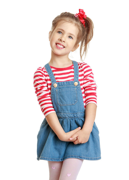 Adorable little blond girl in a denim dress. - Photo, Image