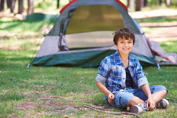 Tent, camping or portrait of happy child in nature for playing, adventure or holiday vacation in park. Relax, confidence or male child with smile in woods, garden or forest for fun hiking or wellness. - Photo, Image