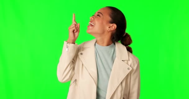Green screen, pointing up and happy woman excited for mockup advertising space, sales promotion or news announcement. Brand notification, chroma key and person gesture at choice on studio background. - Footage, Video