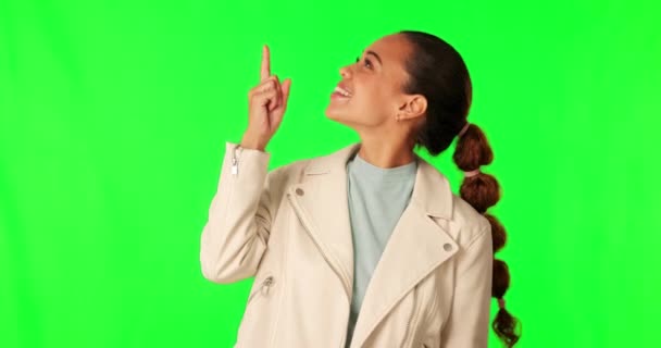 Green screen, happiness and woman advertising, pointing up and gesture at mockup space, sales promotion or commercial. Discount information, chroma key portrait and brand person on studio background. - Footage, Video