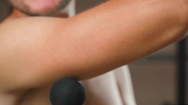 Working out the triceps with a percussion massager, close-up. A guy massages his arm muscles after a workout. High quality 4k footage - Footage, Video