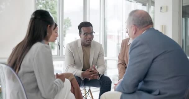 Psychology, comfort and black man with group to talk about problem, depression or mental health. Therapy counselling, support or community of people with empathy, help and healing in rehabilitation. - Footage, Video