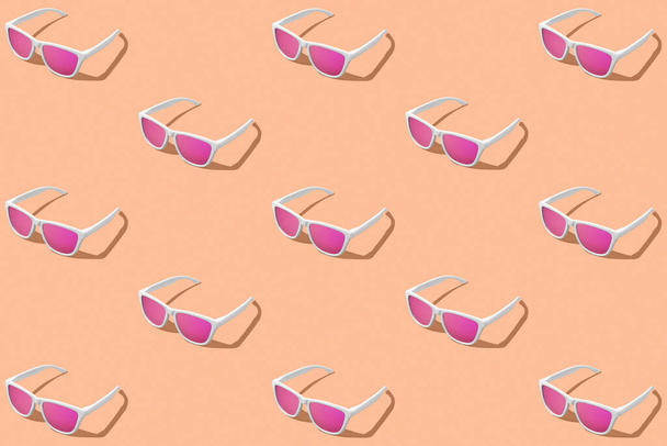 3D Render patrón de gafas de sol de color rosa con fondo de color Melocotón Fuzz. Grabado en estudio. Color del año. - Foto, imagen