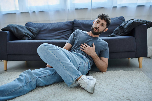 anxious traumatized man in casual home wear having severe panic attack, mental health awareness - Photo, Image