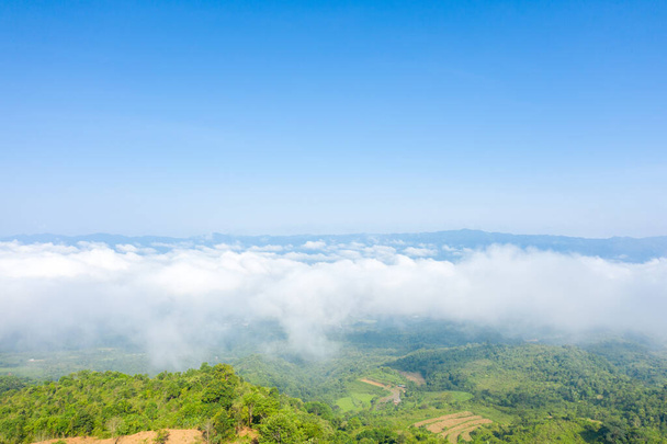 This landscape photo was taken, in Asia, in Vietnam, in Tonkin, in Dien Bien Phu, in summer. We see the clouds above the city seen from the green mountains, under the Sun. - Photo, Image