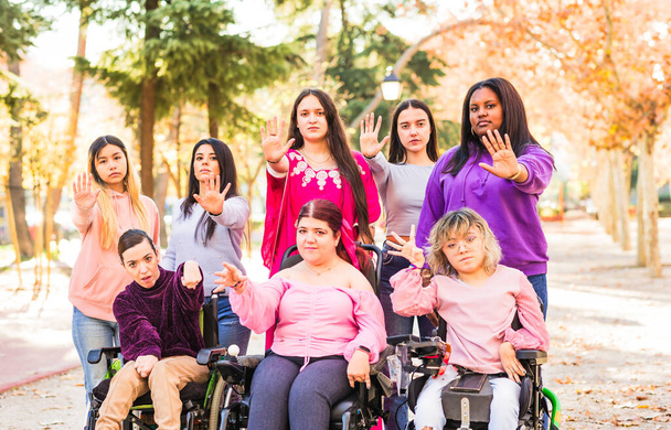 Femenino Grupo multiétnico con mujeres discapacitadas, apoyo con la inclusión social de la hermandad contra la agresión. Movimiento feminista por la igualdad de género - Foto, imagen