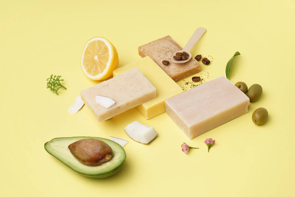 Composition with soap bars and natural ingredients on yellow background - Photo, Image